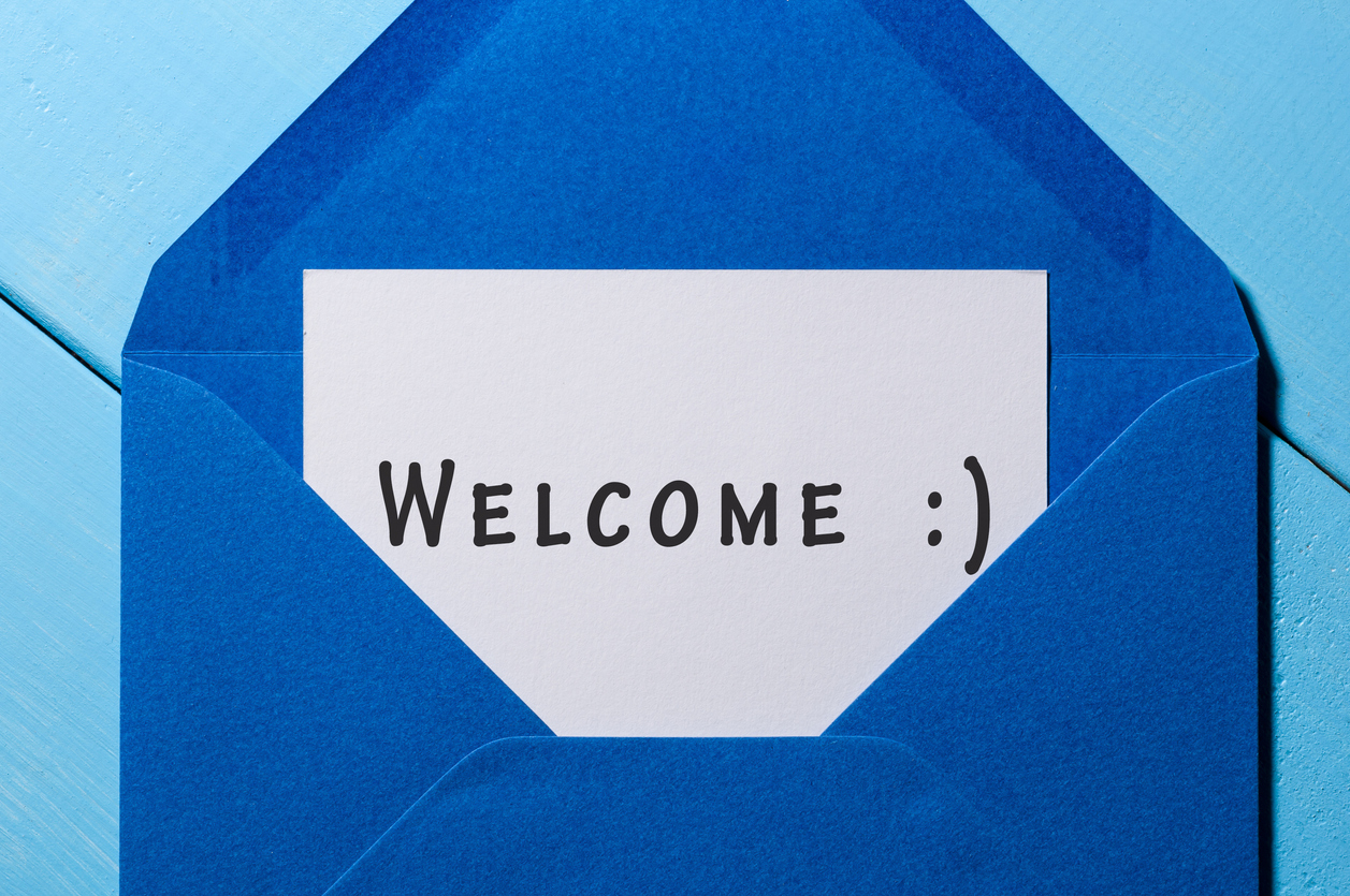 Welcome inscription. Hand drawn letter in blue envelope